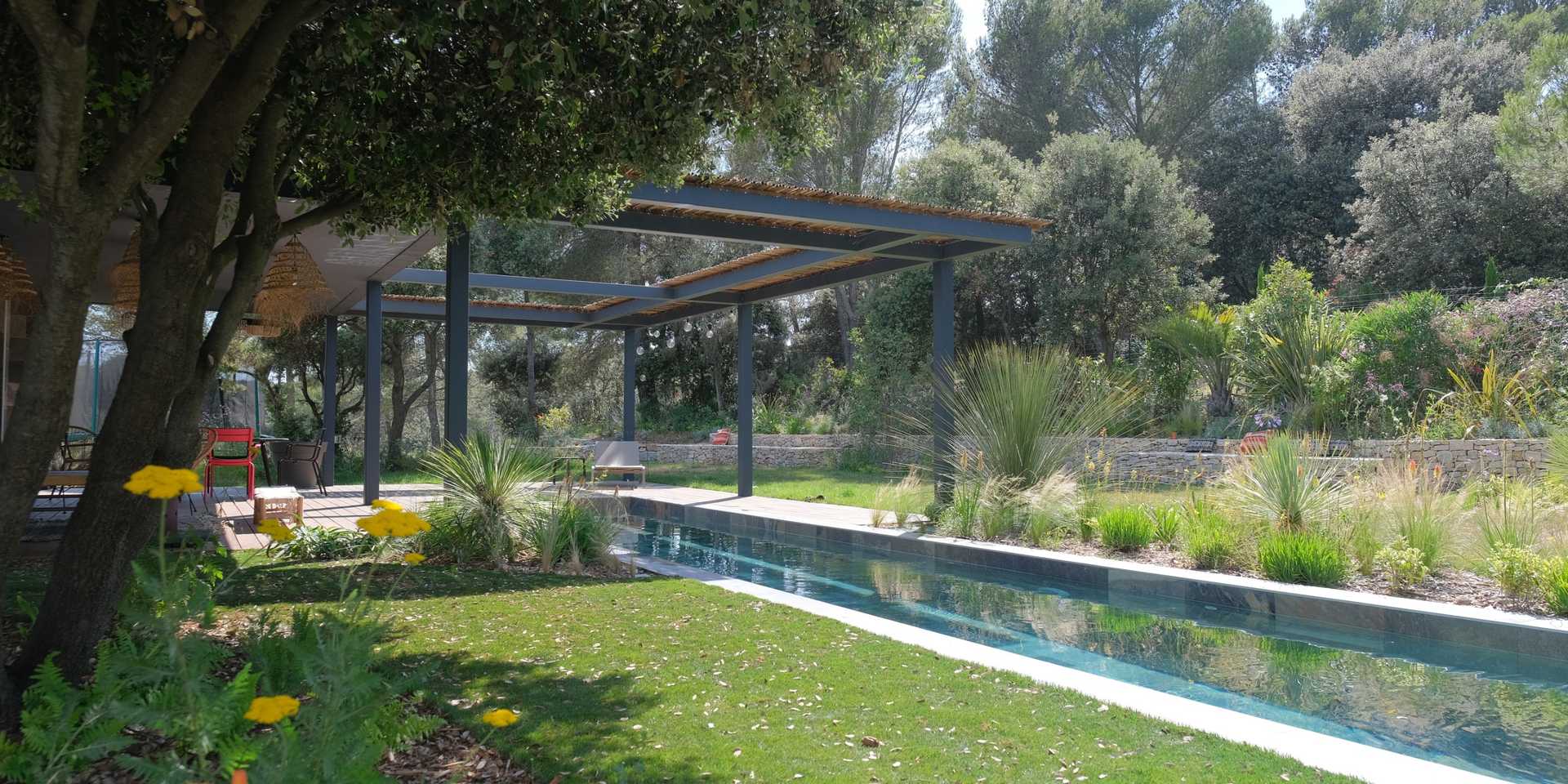 Garden with swimming pool designed by a landscaper in Bas-Rhin